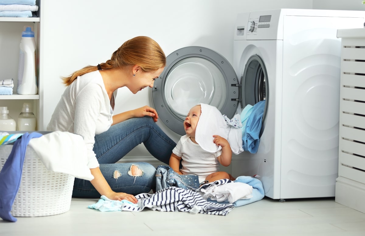 Woman And Baby Playing With Laundry Min